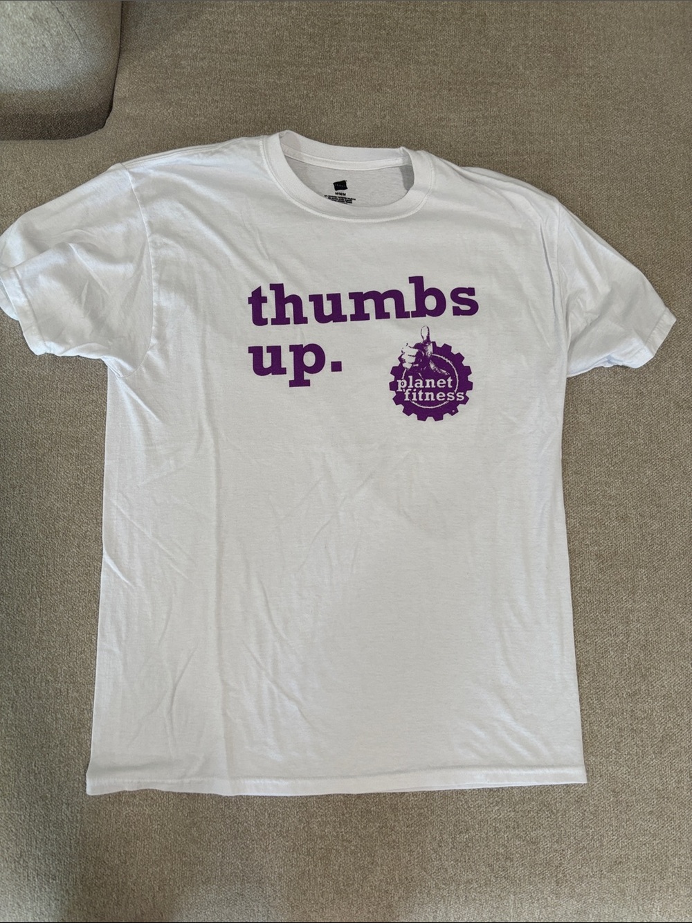 White Tee with Purple "thumbs up." Planet Fitness Logo
